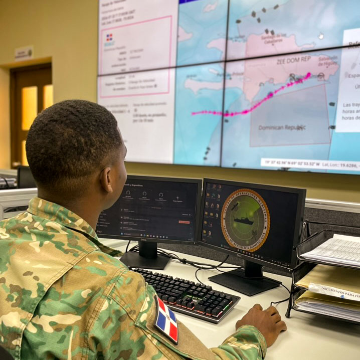 serviceman at a control center looks at the Skylight AI app on a large wall display