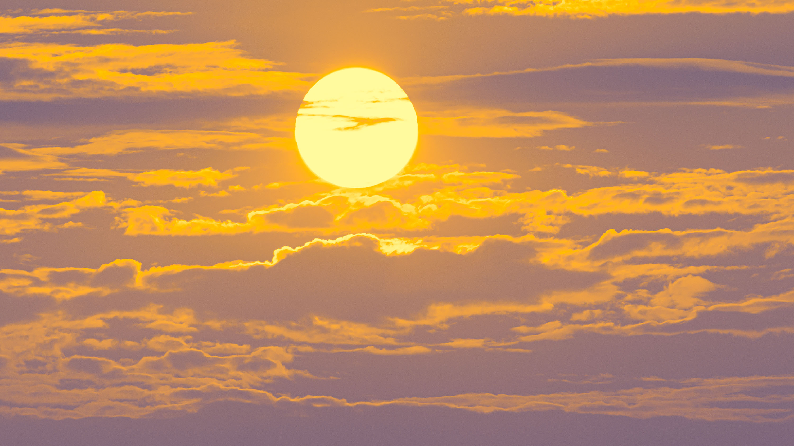 sun behind clouds