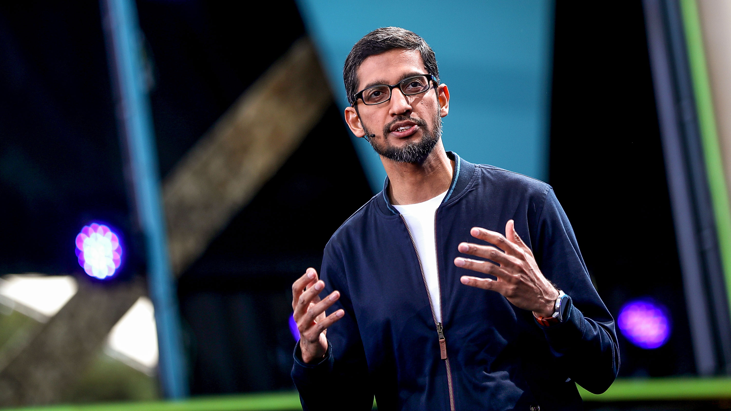 Sundar Pichai speaking on stage at a Google I/O conference