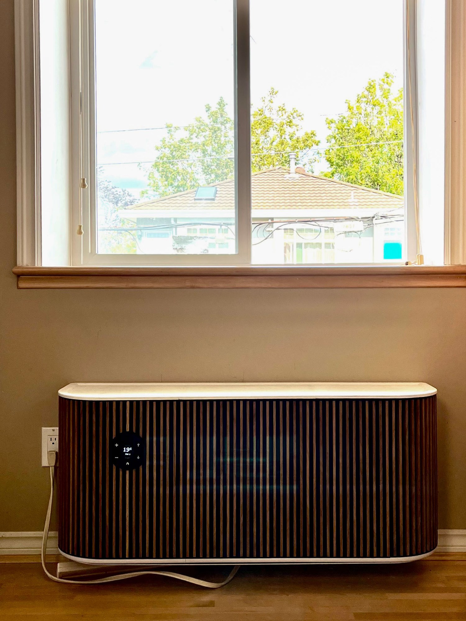 brown HVAC unit below a window