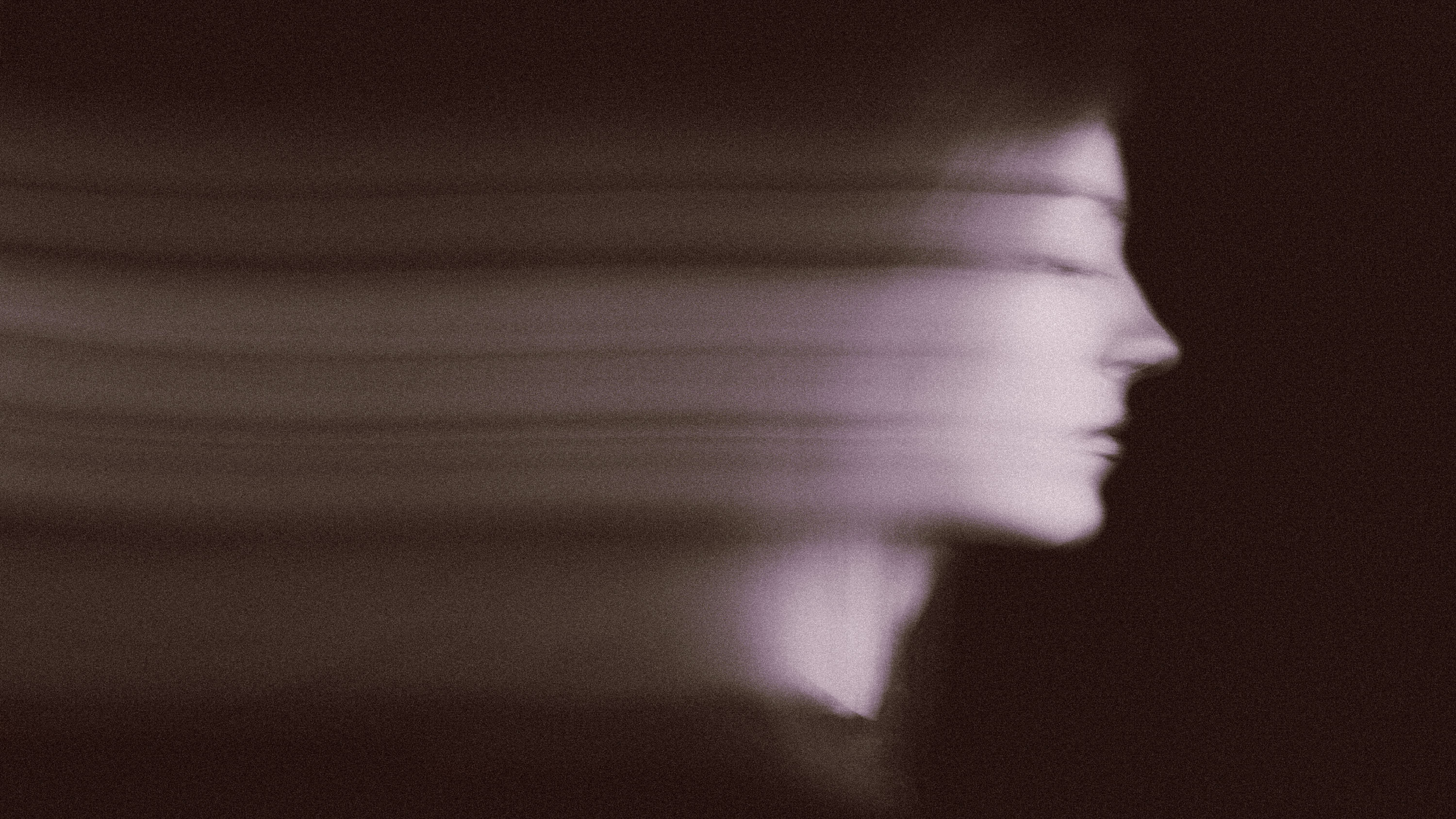 Blurred female portrait in the dark.